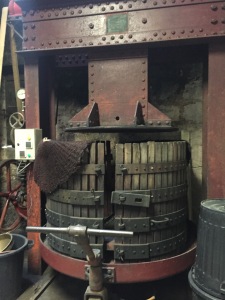 This press is about 100 years old. The chateau purchased a modern press, but ultimately decided to go back to this one because of the quality of juice they can get from it. 